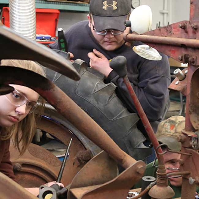 Students working on a tractor