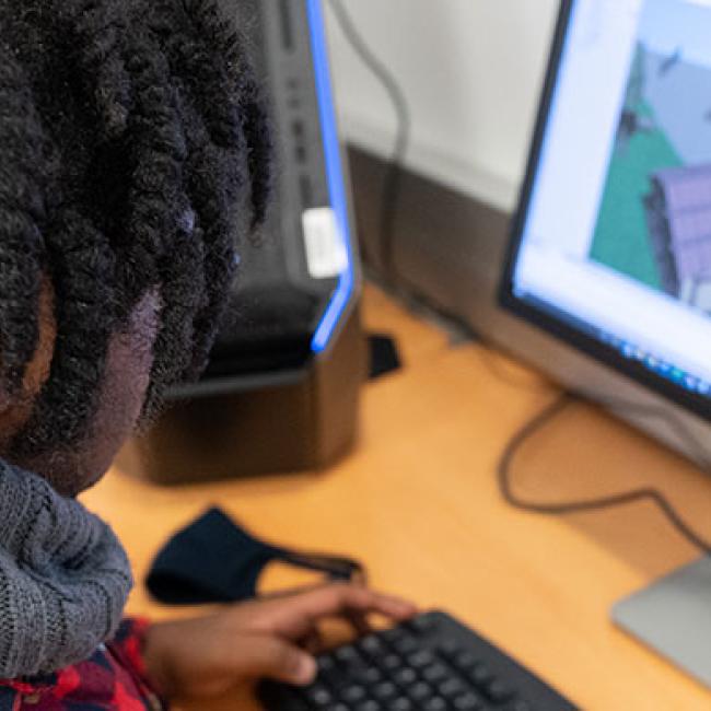 A student works on a game in the Unity engine.