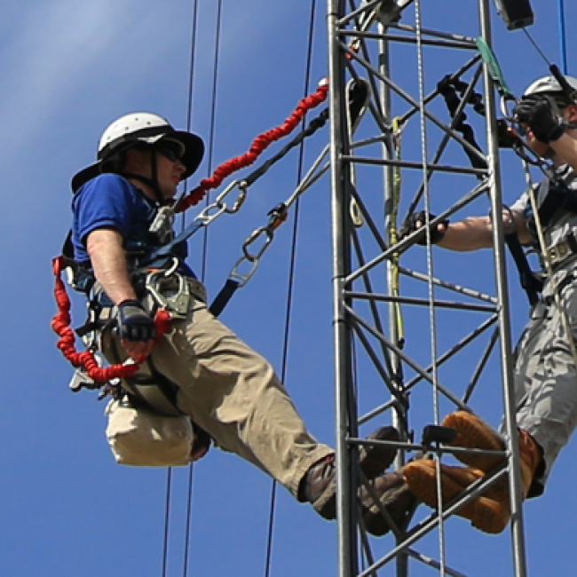 Students climbing an electrical thing