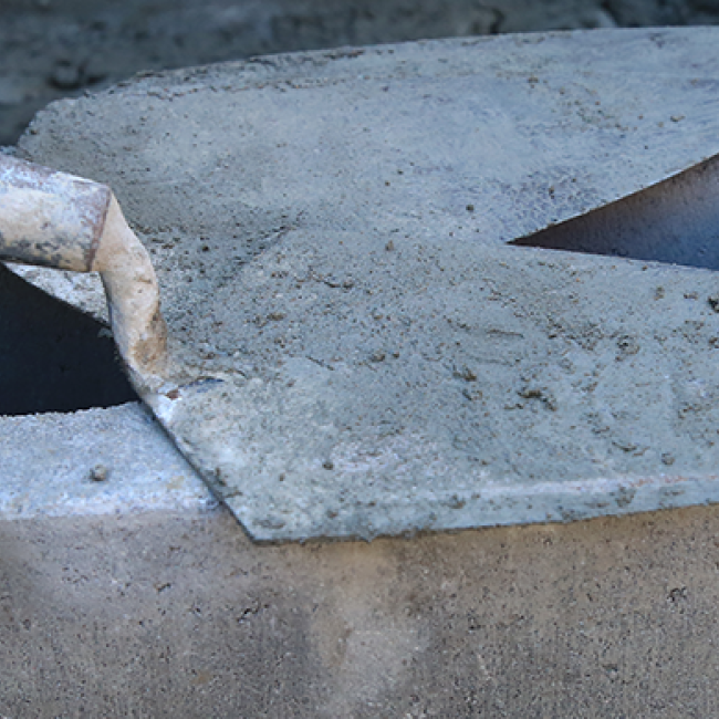 Some trowels resting on a cinderblock