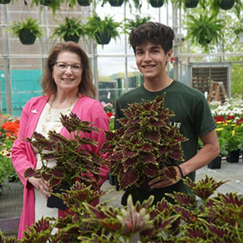 Student Gareth March prepares for the annual plant sale alongside Provost Suzan Harkness