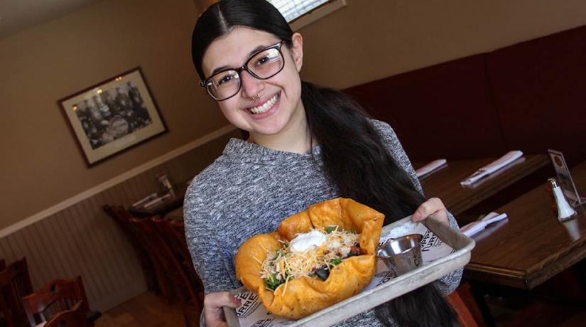 student holding taco bowl