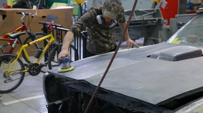 Student working on car hood