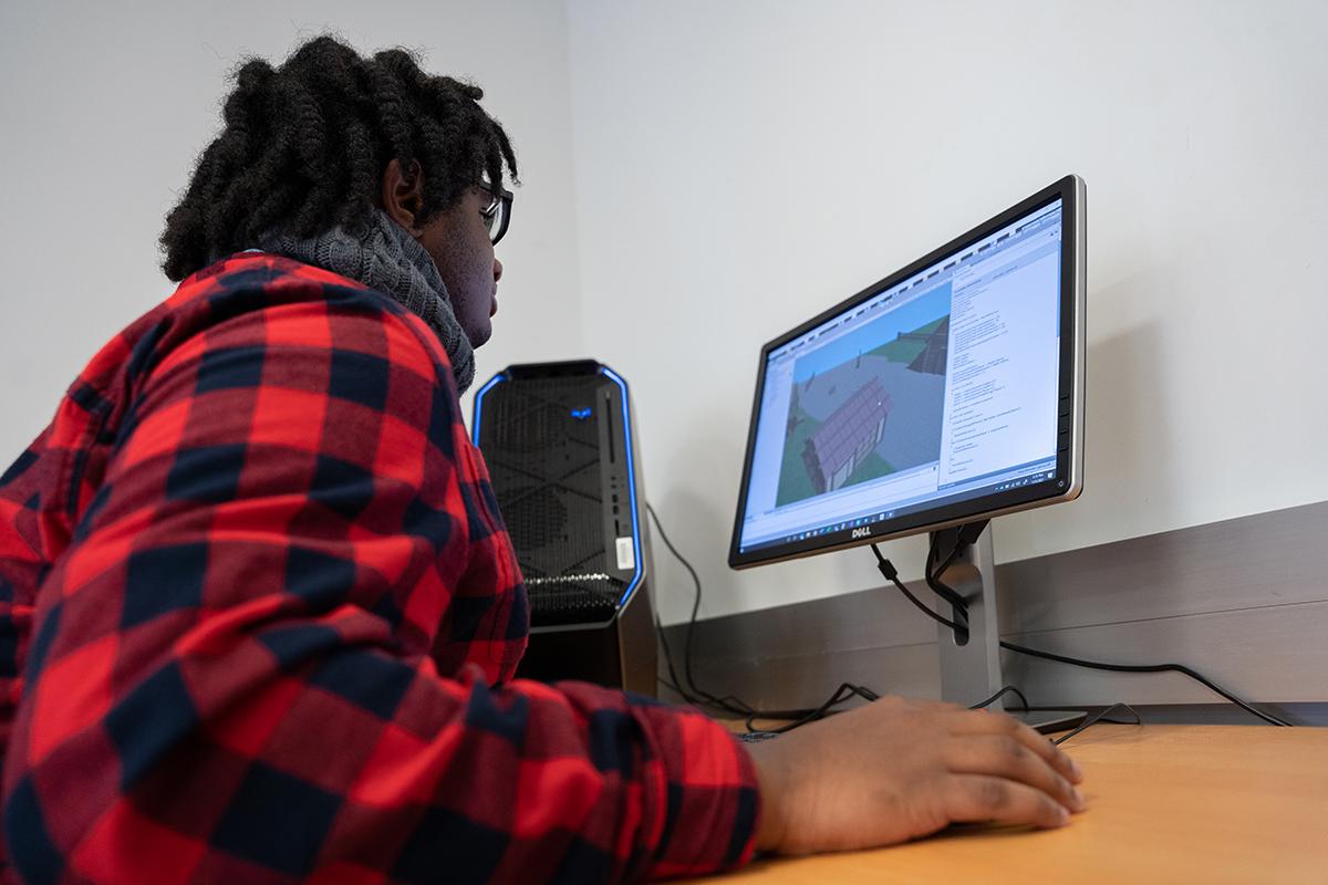 A student works within game engine to create interactive world.