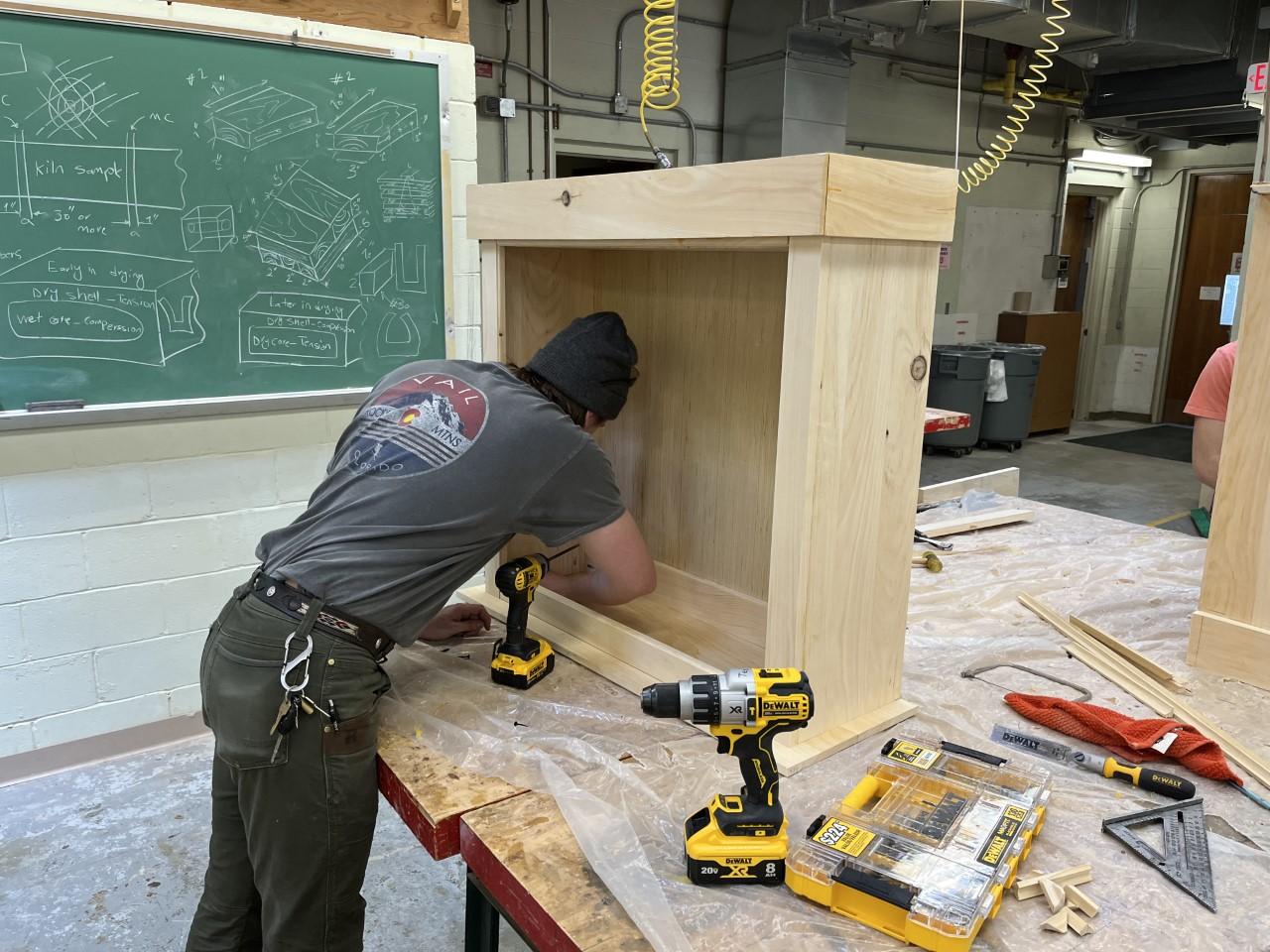 A wood products technology student works on a project