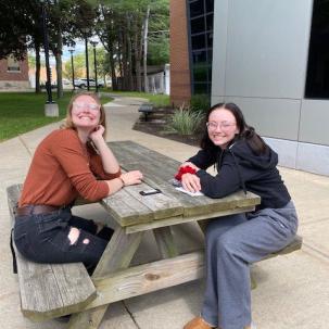 Norwich students hang out in front of Follett Hall.