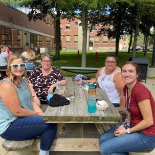 Norwich students hang out in front of Follett Hall.