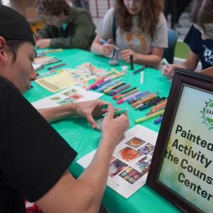 Students participate in a painted rock activity with the Counseling Center during SUNY Morrisville's Earth Day Celebration.