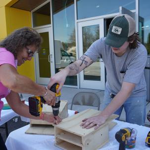 Students build bat boxes with the Wood Products Technology program during SUNY Morrisville's Earth Day Celebration.