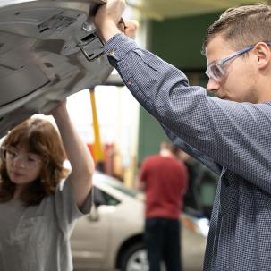 Morrisville Alum Alexander Graf works with a student in the Auto Body program.