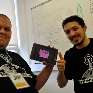 Two people showing off their game on a tablet.