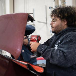 Auto student Manny Melendez at work in Alex Graf's lab 