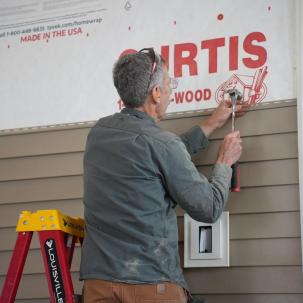 Jim Bright putting siding on the house 