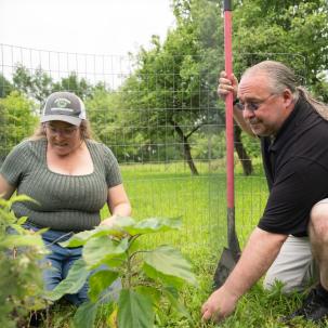 Jeff Monette plants with Professor Jennifer Gilbert Jenkins at the food forest 