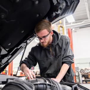 Automotive student Ty Paddleford works on the 2024 Mustang