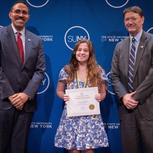 Laura Bedell poses with her Chancellor's Award for Student Excellence