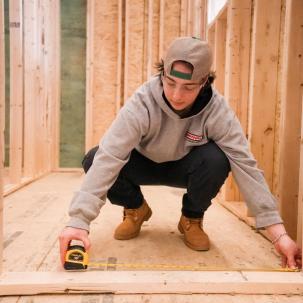 Residential construction student Tilly Couture measures in lab 