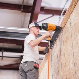 Residential construction student Bennett Schoonover works on the house 