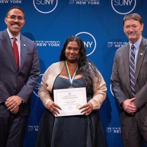 Vidya Jawahir poses with her Chancellor's Award for Student Excellence
