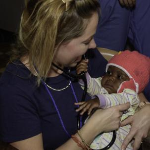 Elizabeth Noble holds a baby.