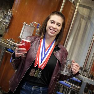 SUNY Morrisville agricultural business BBA student Mary Cosenza was presented with a bronze, silver and gold medal after helping Morrisville place in three of the five categories during the 2018 U.S. Open College Beer Championship (Photo credit Sarah Marcellus, MAC Associate Graphic Designer).
