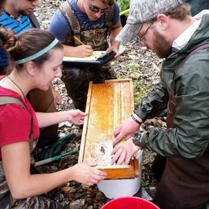 Two students measuring a fish