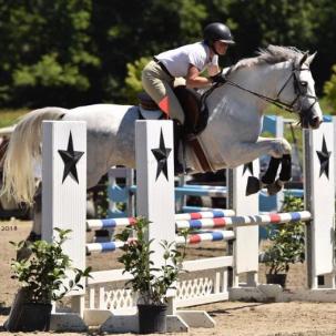 Student jumping a horse