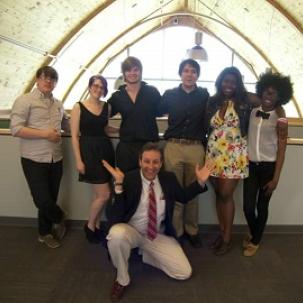 Students in the Architectural Studies and Design program celebrate with a faculty member after the final design review of the semester is over.