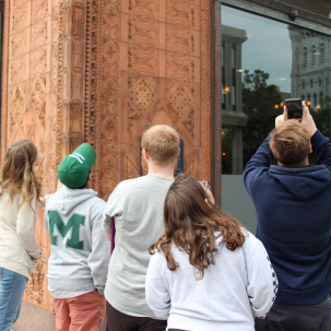 Architectural Studies and Design students gaze up at the Prudential (Guaranty) building in while on a walking tour of downtown Buffalo, New York.