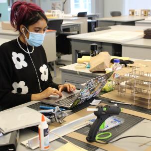 An Architectural Studies and Design student works in the design studio.
