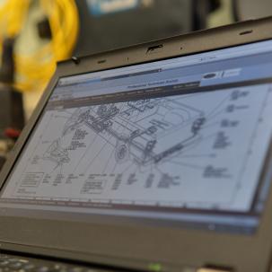 A vehicle schematic displayed on a laptop