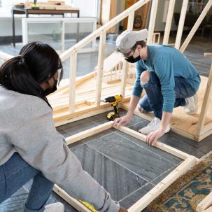 Architecture students build a frame.