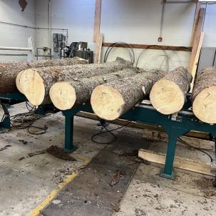 Log conversion and lumber manufacturing utilizing wood primary processing lab (saw mill).